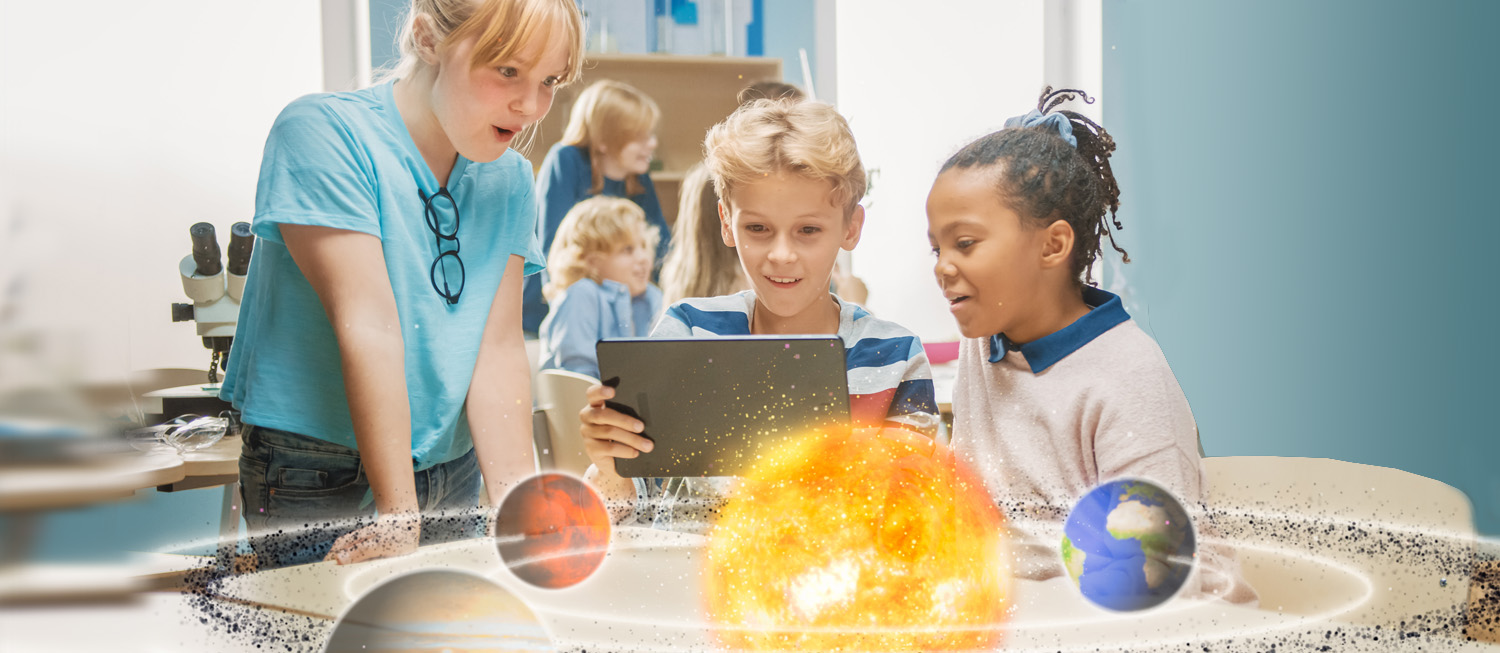 Children using a tablet to view an augmented reality solar system model in a classroom